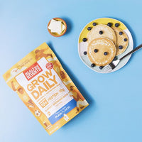 Healthy Heights Grow Daily Protein Shake for Boys – Ages 10+ - Pediatrician-developed Healthy Heights Grow Daily protein shake pack beside a plate with three pancake-style growth shakes. - Healthy Heights